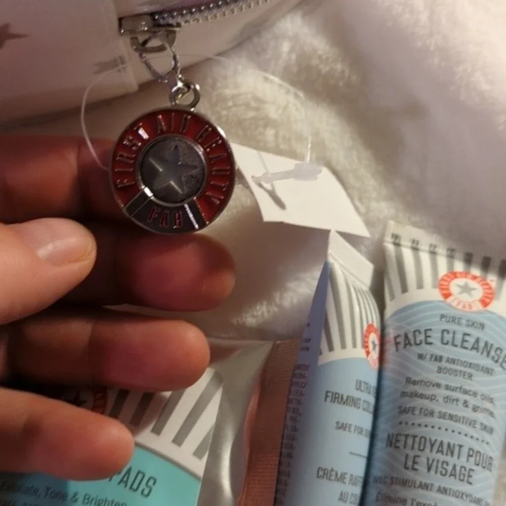 First Aid Beauty Cosmetic bag with three trial size products